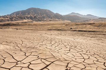 Climate change effects, dry sand field where a while ago there was water now remains the eroded...
