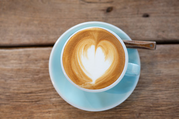 Latte arts coffe hot coffee on wooden table.barista art concept.