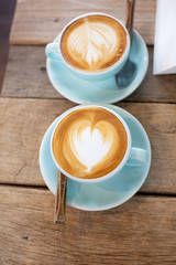 Latte arts coffe hot coffee on wooden table.barista art concept.