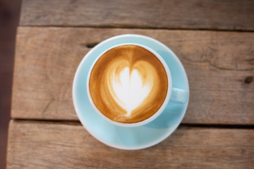Latte arts coffe hot coffee on wooden table.barista art concept.