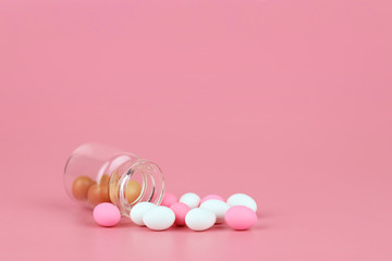 decorated easter eggs in bottle with pink background