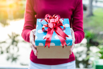 Closeup on hands giving a gift box with copy space for Birthday, Christmas and New year, Valentine's, Graduate, Celebrate.  