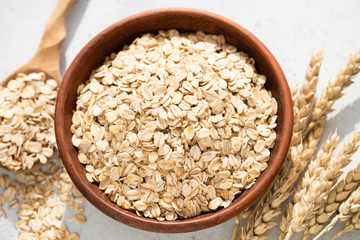 Oats, oat flakes or rolled oats in a bowl. Closeup view. Healthy clean eating food, healthy lifestyle concept