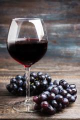 Red wine in glass on the rustic background. Selective focus. Shallow depth of field.