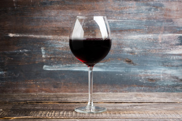 Red wine in glass on the rustic background. Selective focus. Shallow depth of field.
