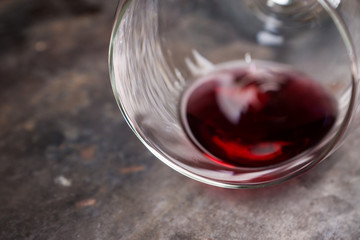 Red wine in glass on the rustic background. Selective focus. Shallow depth of field.
