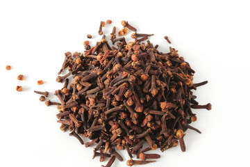 heap of dried spice clove aromatic flower buds ion white background