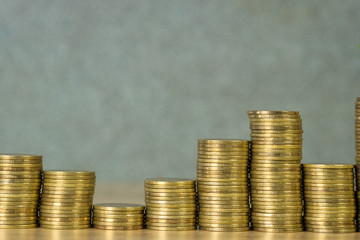 Columns of gold coins, piles of coins on working table, business banking and financial concept.