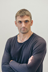 Obraz premium handsome man shows off gray clothes on white background