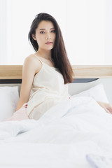  Asian woman model sitting and posing on bed..