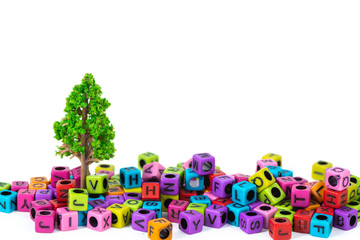 Pile of letter bead or beads with alphabet and little tree on white background.
