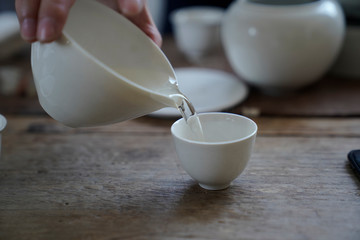 Tea wares placed on wooden shelves and tables