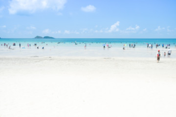 Blur group of people are doing activity on the beach with sand sea and bright sky with sunshine day. for background.