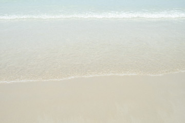 Soft wave of blue and green ocean/sea on sandy beach. Empty copy spac background.
