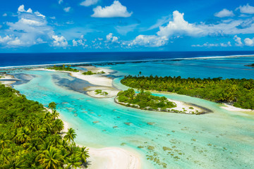 Rangiroa aerial drone video of atoll island motu and coral reef in French Polynesia, Tahiti. Amazing nature landscape with blue lagoon and Pacific Ocean. Tropical island paradise in Tuamotus Islands. - obrazy, fototapety, plakaty