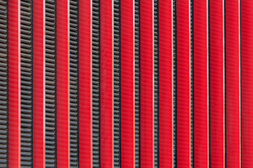 Background image - vertically positioned decorative panels in red with black bars between them.