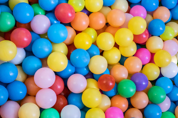 Fototapeta na wymiar Top view many colorful plastic gum balls in kid playroom at indoors playground.