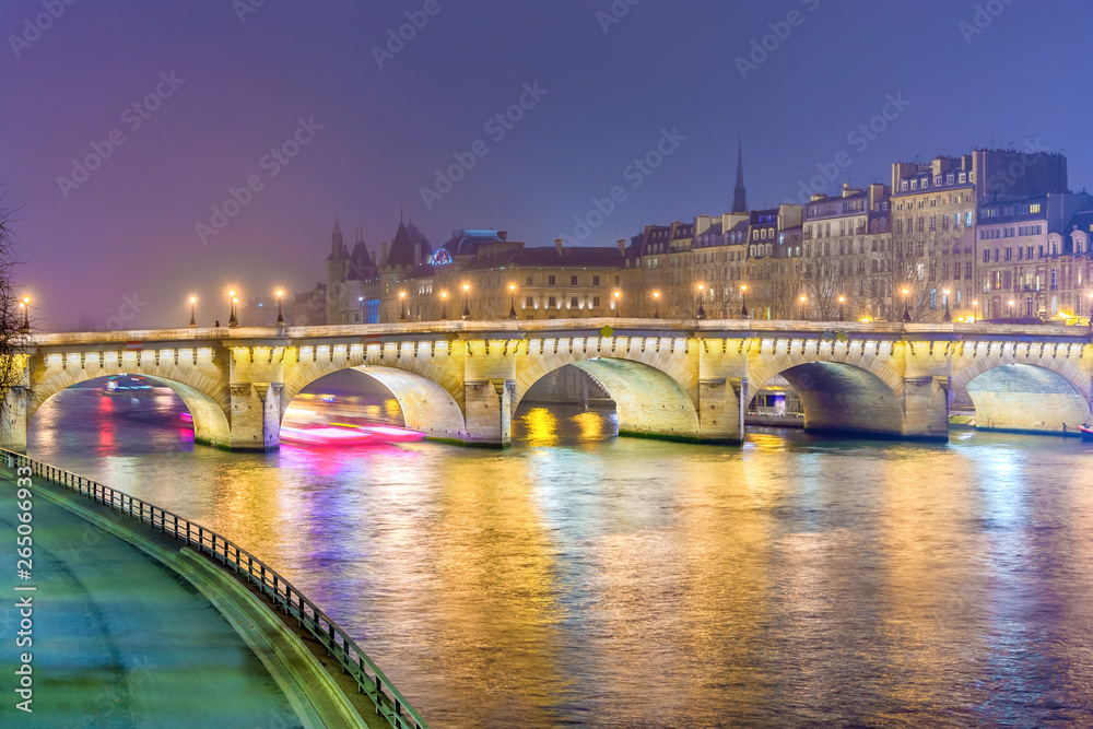 Wall mural Night view of  Paris, France. Illuminated Pont neuf (New Bridge) is oldest bridge across the river Seine.