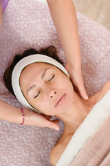 Obraz na płótnie Canvas Professional masseur doing neck massage for young woman