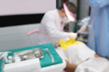 Fototapeta na wymiar Blurred image photo of dentist and his assistant are working in clinic.