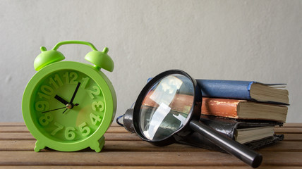 clock and books on table