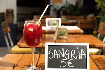 Glass of sangria and menu board in street cafe of Andalusia, Spain