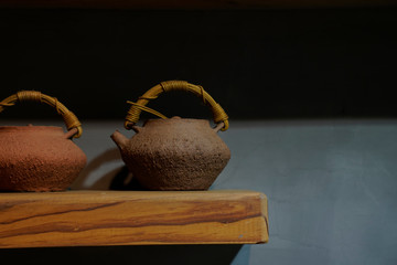 A clay teapot placed on a wooden table