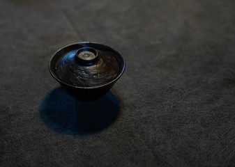 A cup with a lid on a black background