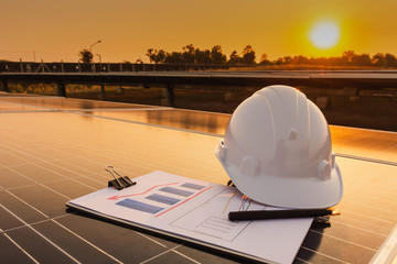 Engineers are examining the performance graph of energy production from solar panels that are...