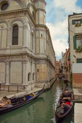 Venetian gondola in canal waters of Venice Italy