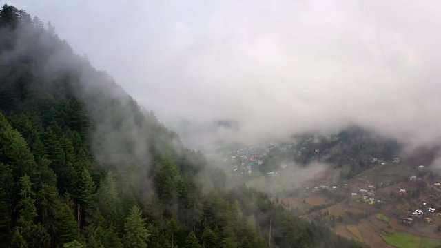 Aerial footage of flying through the clouds.
This was shot in India on a Foggy Day. 
Serene forests and dreamy clouds. 
Cinematic Drone videos of High altitude Flying over
An alpine forest