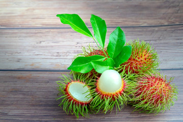 Fresh rambutan - asian fruit on wood background