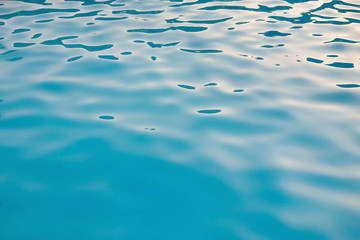 Blurry Light Blue swimming pool water texture reflection