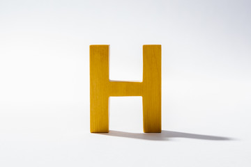 Wooden Alphabet H and Shadow Reflection.