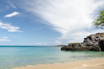 Fototapeta na wymiar Gorgeous clouds reflecting in waters of Waialea beach