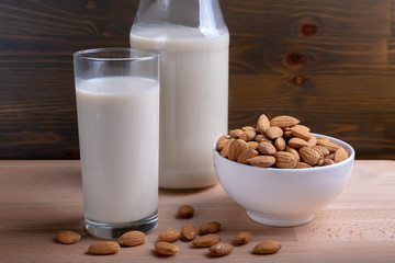 Glass of Milk Almond milk and organic almonds on wooden background, Alternative Milk. Nuts milk