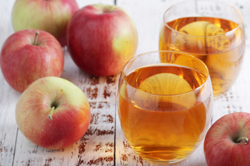 Several apples and glasses with apple juice