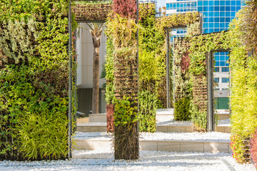 Modern landscape design. Rectangular metal frames like doors covered with green vegetation
