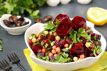 Lean chickpea and beetroot salad decorated with beetroot roses in a white salad bowl