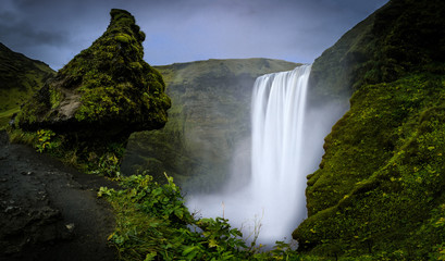 An elevated view of the Skógafoss waterfall in Iceland. A long exposure picture of the waterfall.
