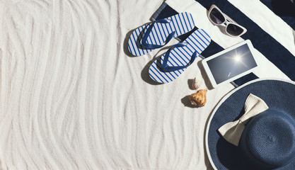 Top view of summer beach accessories on the sand