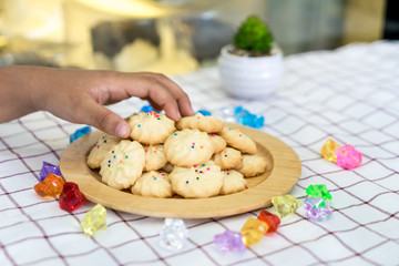 Pile of cookies on wooden plate