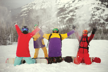 A group of young snowboarders enjoying the snow in the winter resort Sheregesh