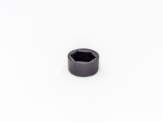 Black plastic hexagonal cover for nut shot on white.