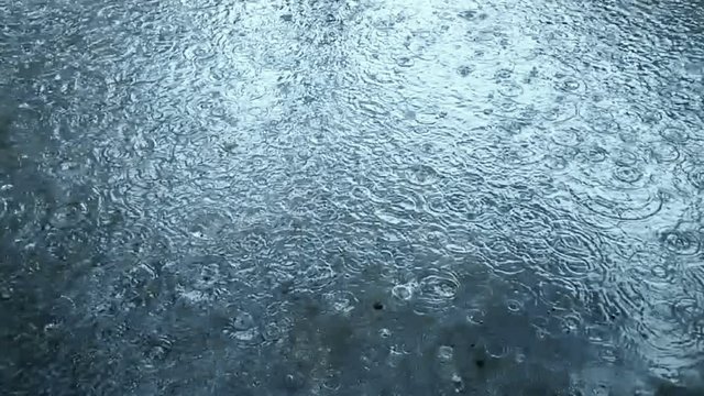 slow motion heavy rain water drops on surface