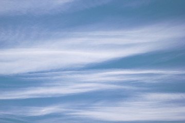 Fototapeta na wymiar Cirro-layered beautiful clouds on a blue sky. Background of light white clouds against blue sky.