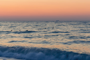 Fototapeta na wymiar Beautiful sunrise or sunset on the sea beach