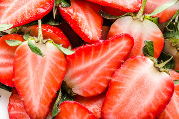 Fresh strawberries background, red texture of strawberry slices.