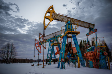 Oil and gas industry. Silhouette oil pumps on a sunset sky background. Toned. Oil industry...