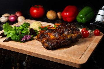 lamb ribs on dark background
